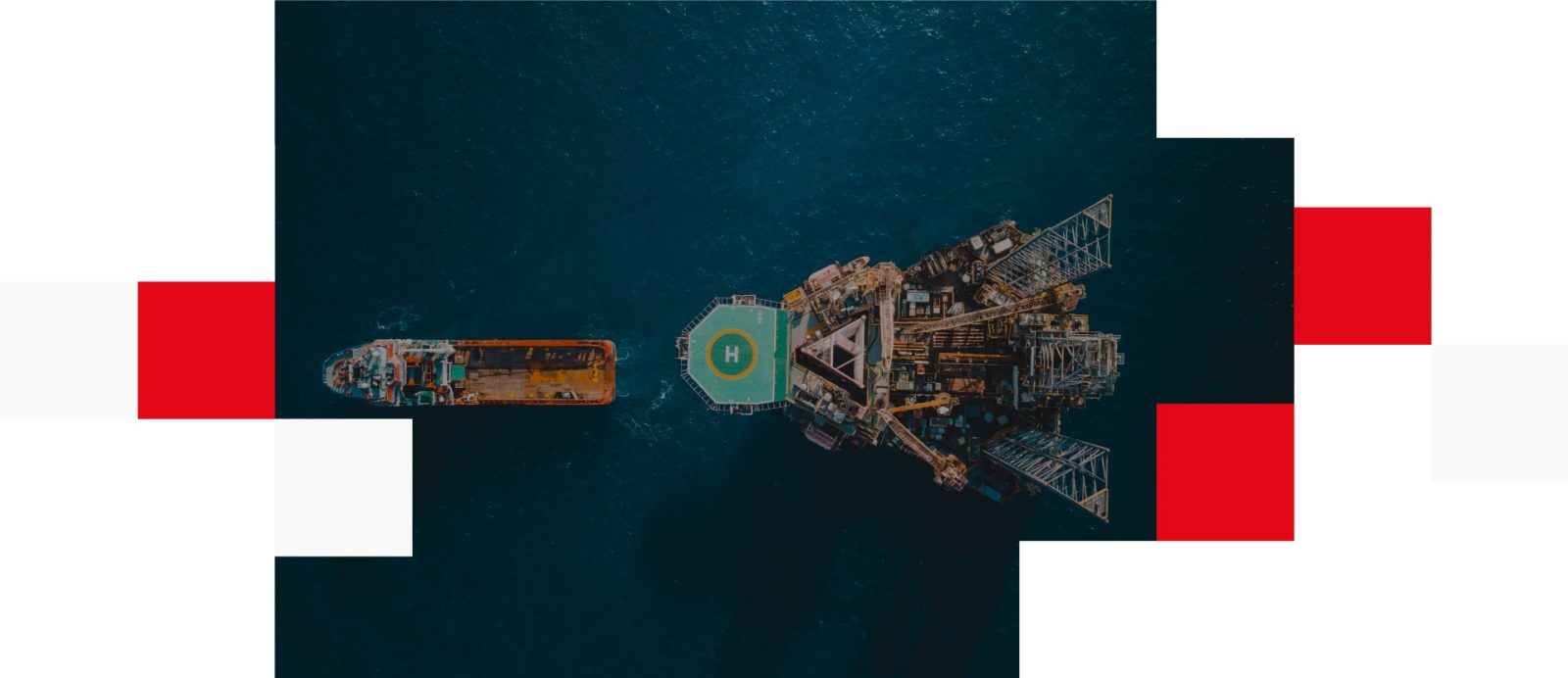 Aerial view of oil rig with towing vessel